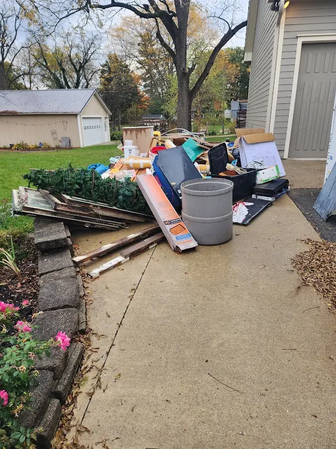 Dumpster being loaded with debris for 12 Yard Dumpster Rental in Camden
